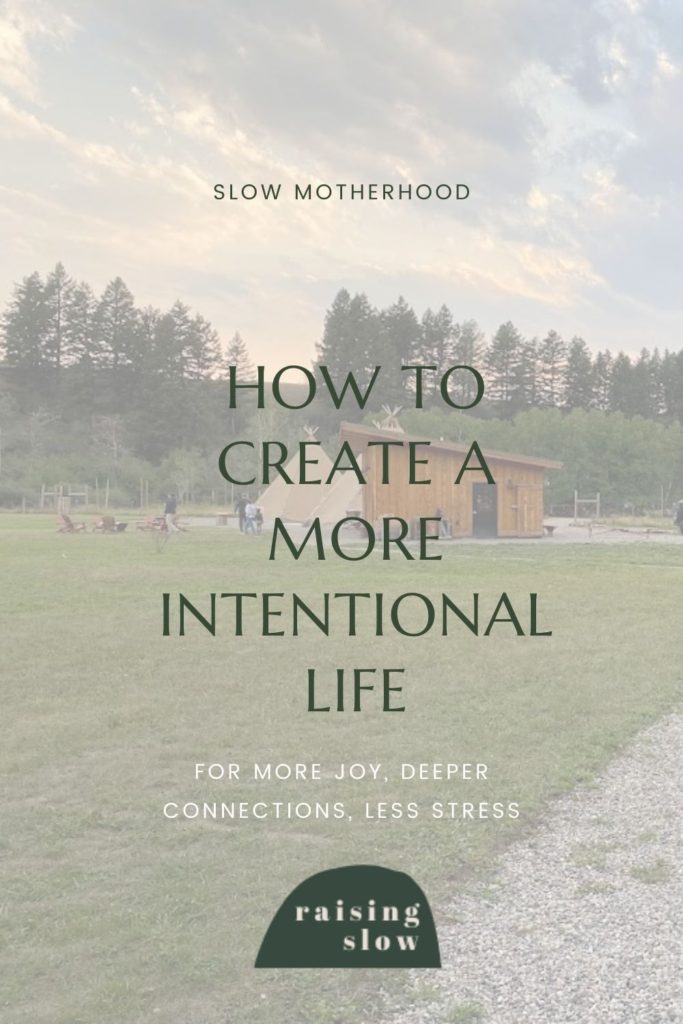 Sunset sky with clouds, tree line, two teepees and a simple building on grass. Text Overlay: Slow Motherhood, How to create a more intentional life for more joy, deeper connections, less stress. Raising Slow