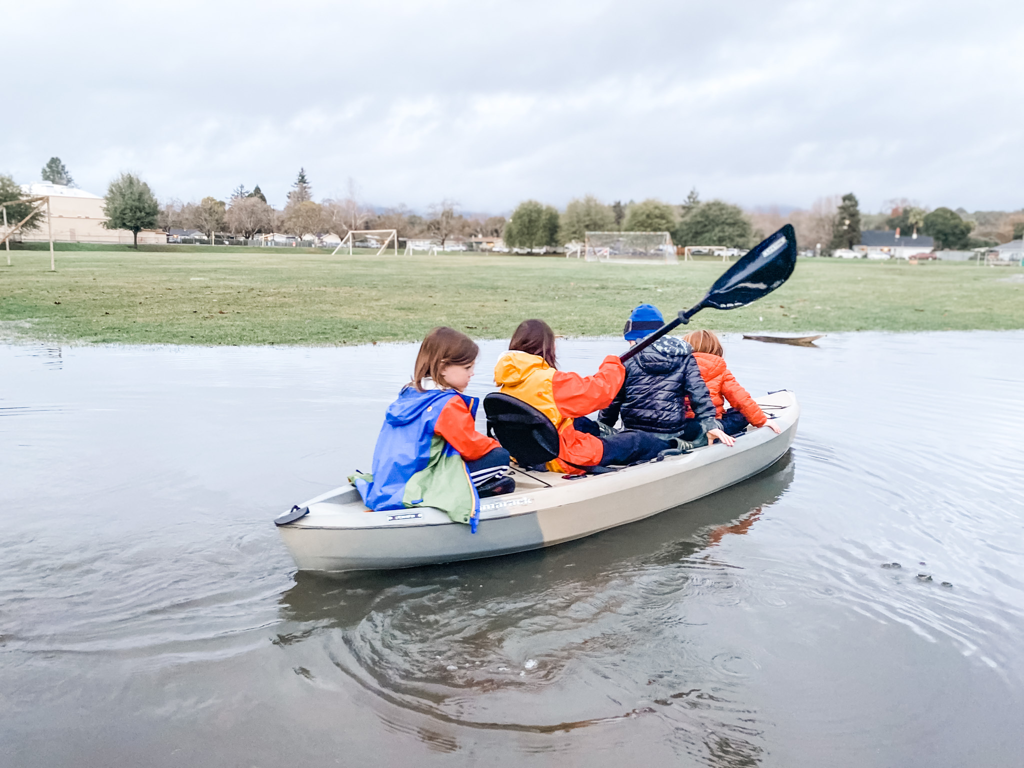 Kids kayaking at a junior high school because of a flood.
