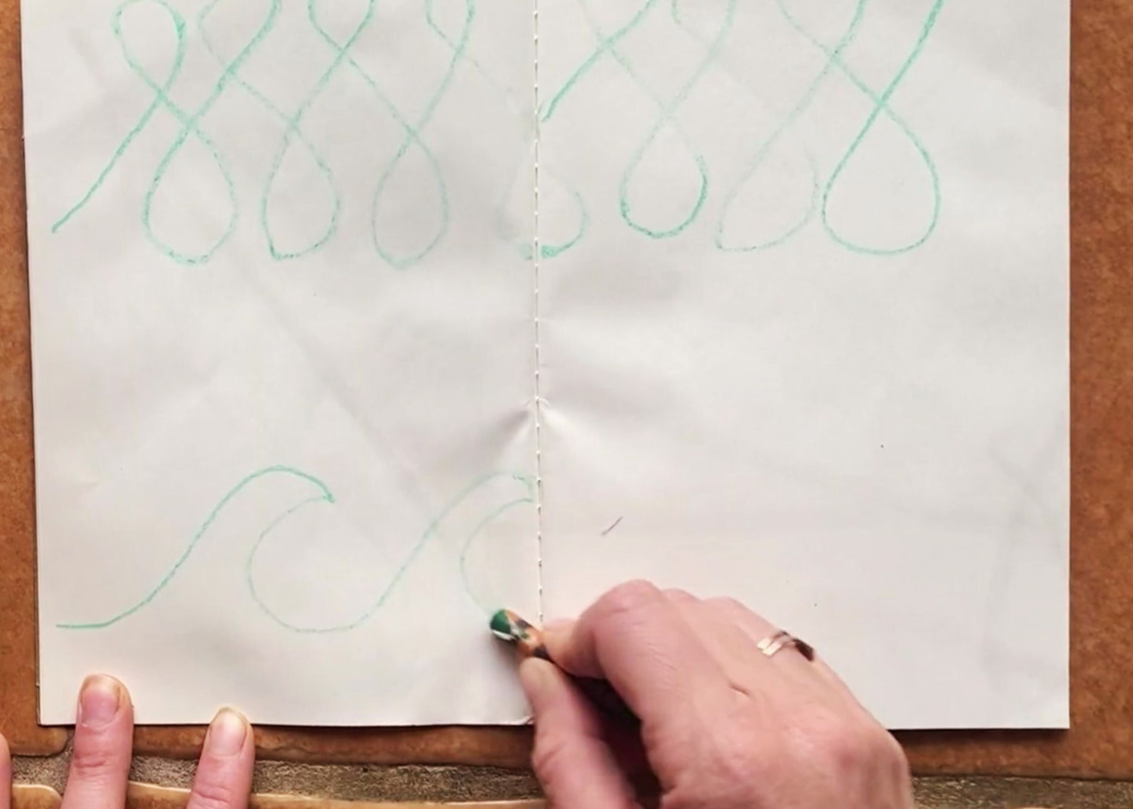 Two different green crayon drawings used to demonstrate breath and drawing. 2 creatives way to build presence.