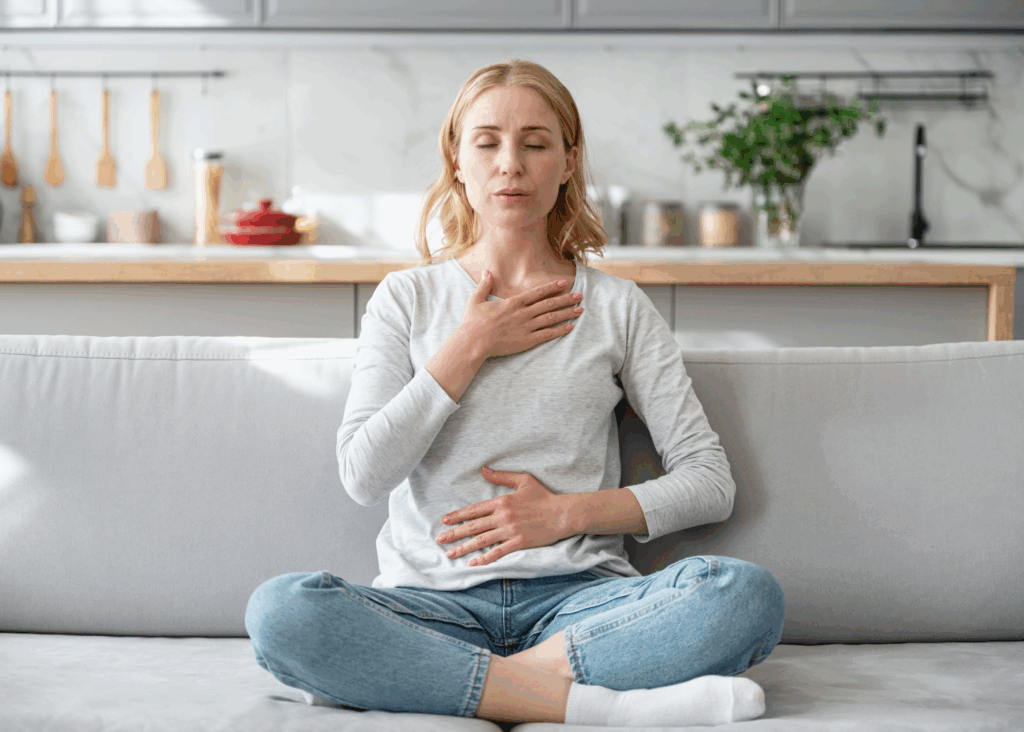 Mom doing breathwork for anxiety and stress on couch