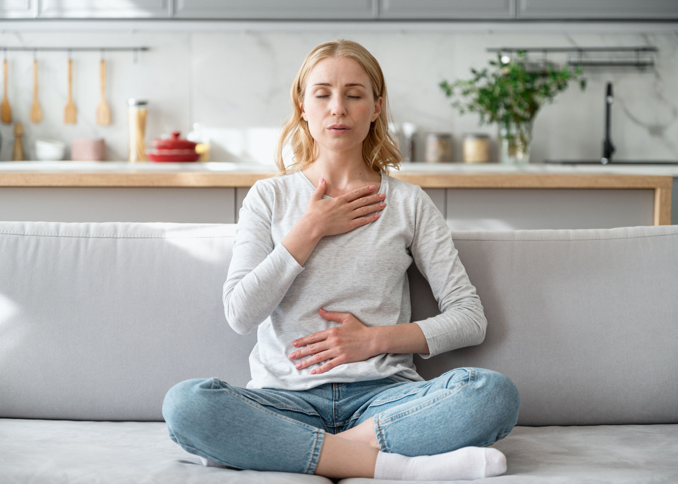 Mom doing breathwork for anxiety and stress on couch