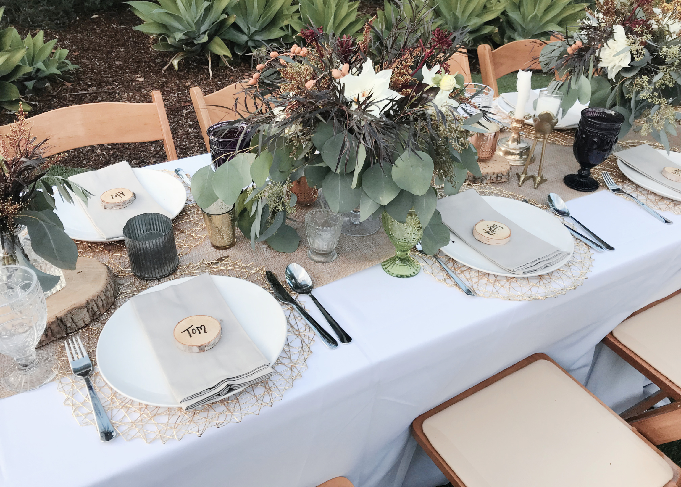 Thanksgiving table before dinner with floral arrangements and name tags